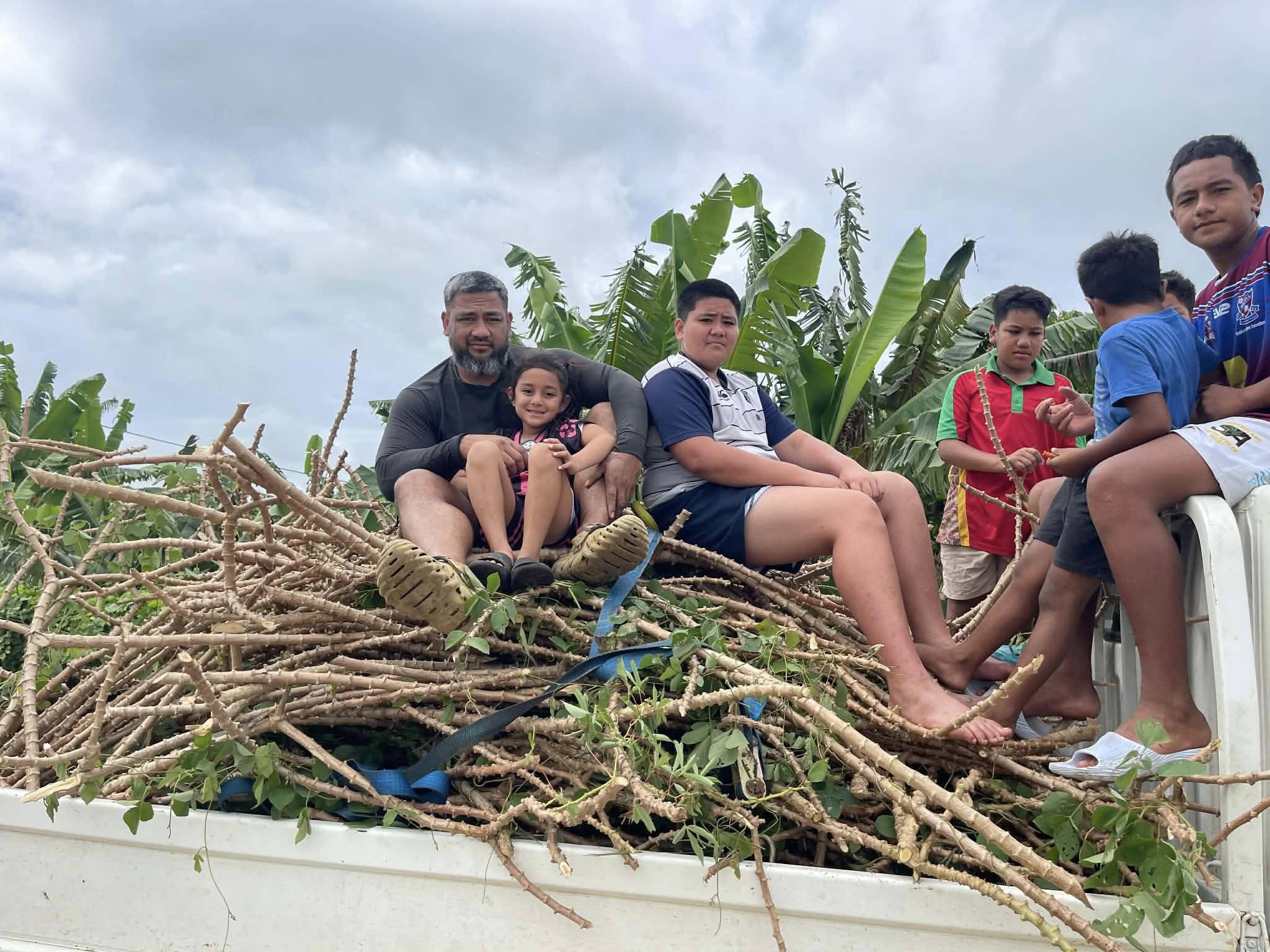 Family on a truck with harvested cassava